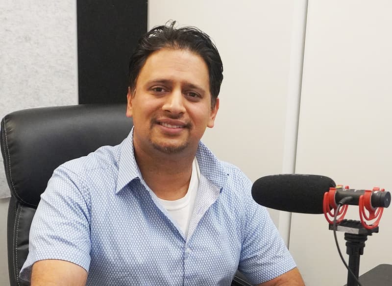 Dinesh Saini, founder of Join Digital Future, seated at a podcast microphone